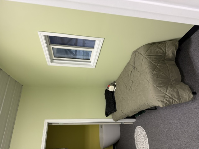 Sharalife private rest room with single bed and adjoining bathroom doorway